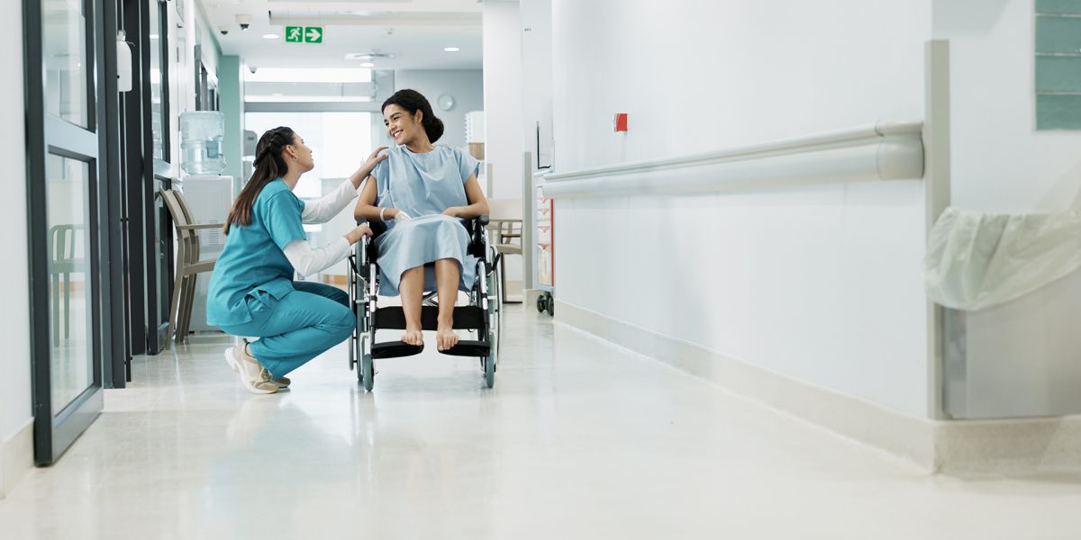 Doctor, wheelchair patient and talking people consulting over healthcare service, wellness surgery or medical support. Clinic, help and medical expert, nurse or surgeon chat to person with disability.