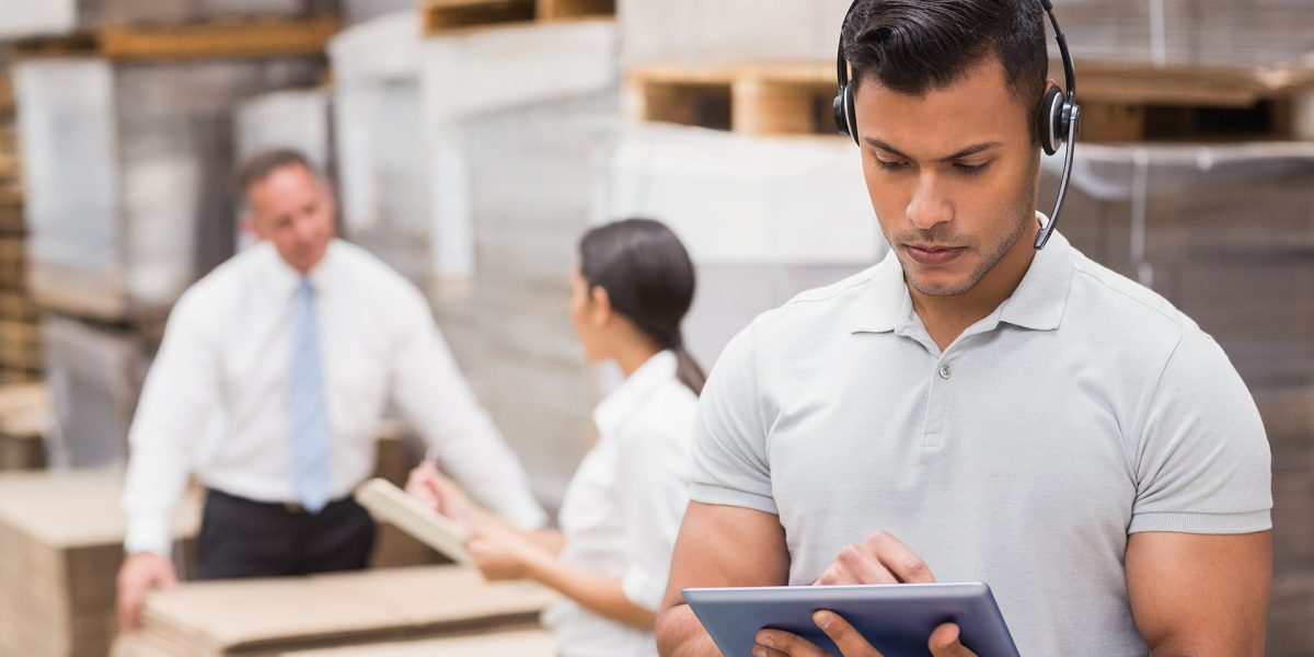 Female manager using digital tablet in warehouse