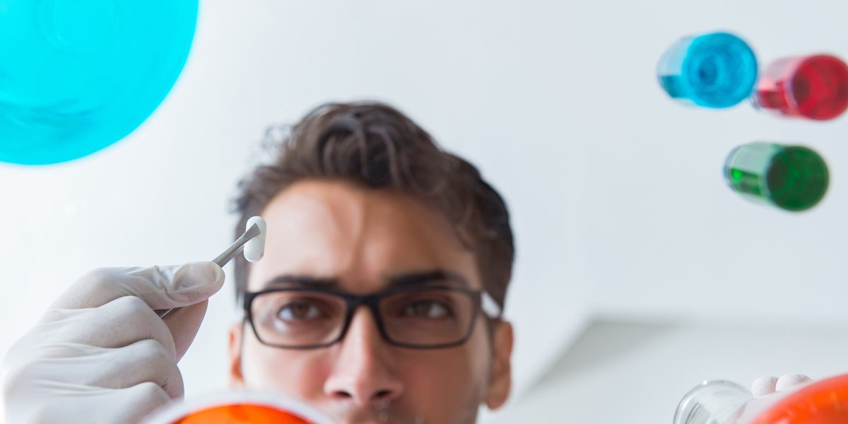 Chemist working in the laboratory with hazardous chemicals